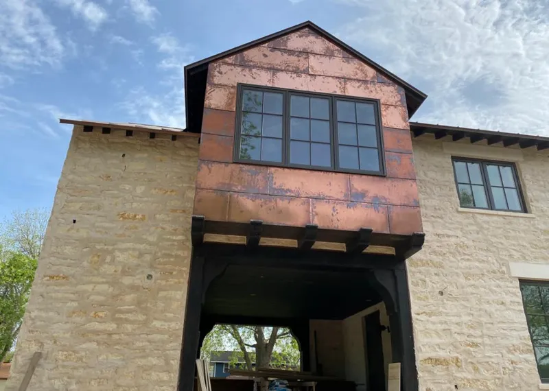 Copper metal panel facade on a stone building for Metal Roof Coating in Mandan