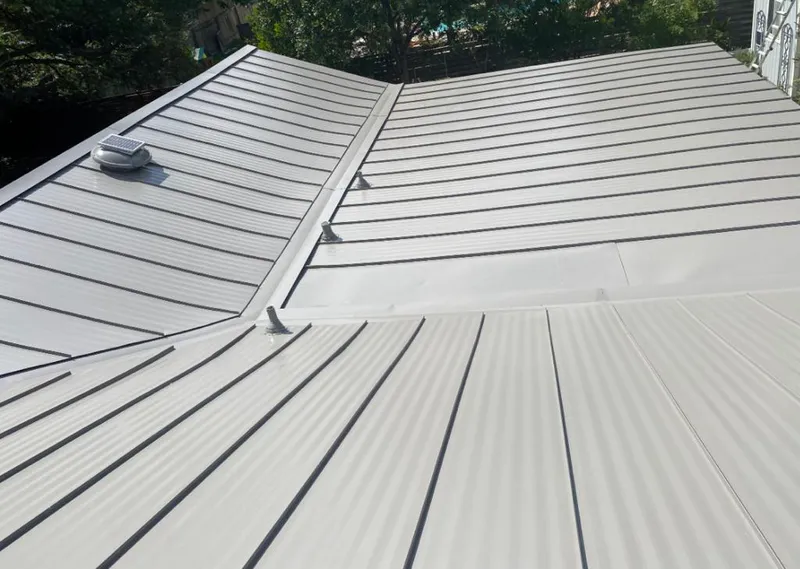 Solar attic fan installed on a metal roof for Roof Ventilation in Mandan